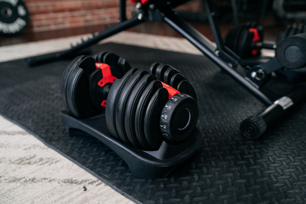 Adjustable dumbbell on gym floor