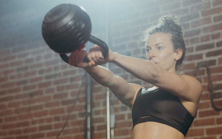 woman using kettlebell for chest exercises